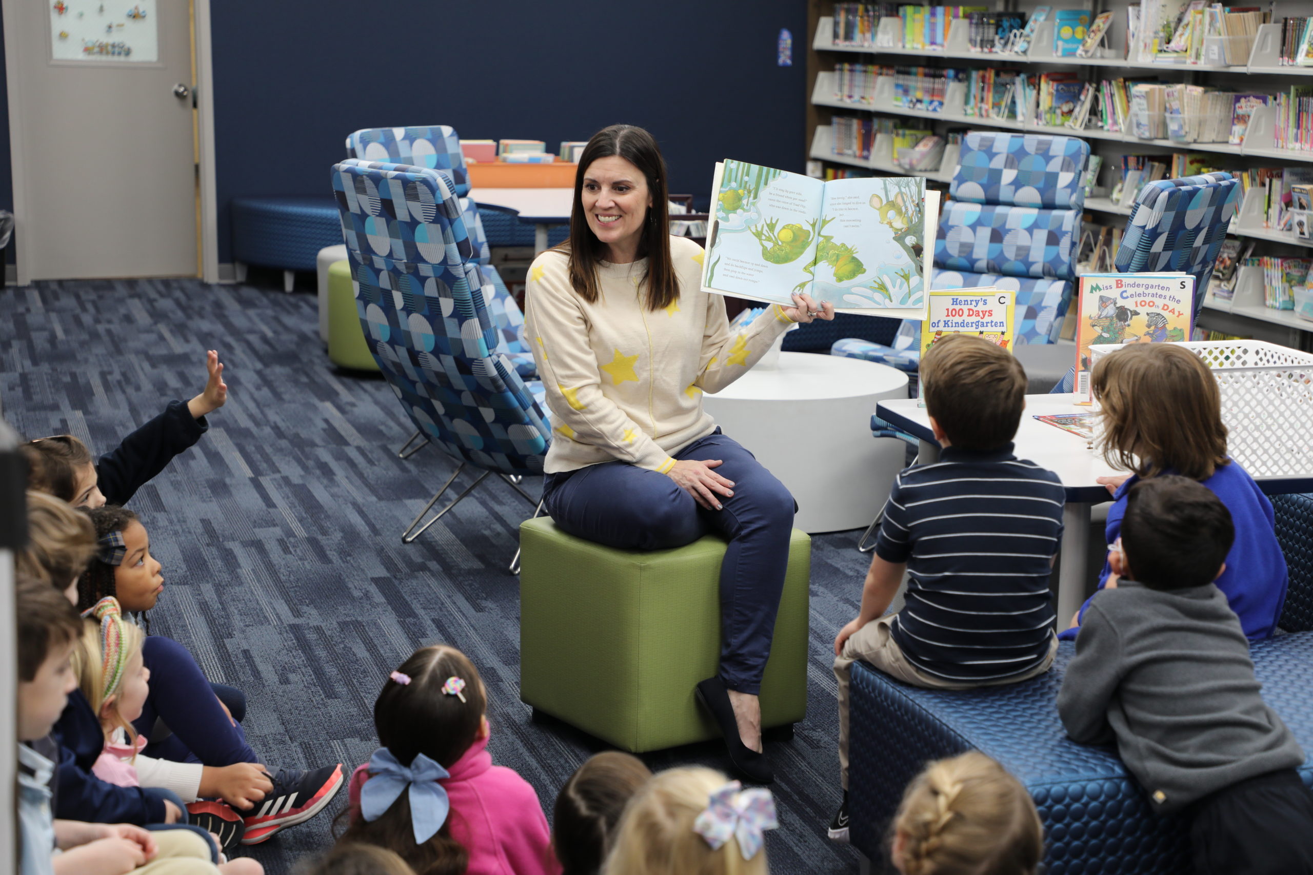 Lower School Librarian Cathy Zeller reads to a group of kindergarten students.
