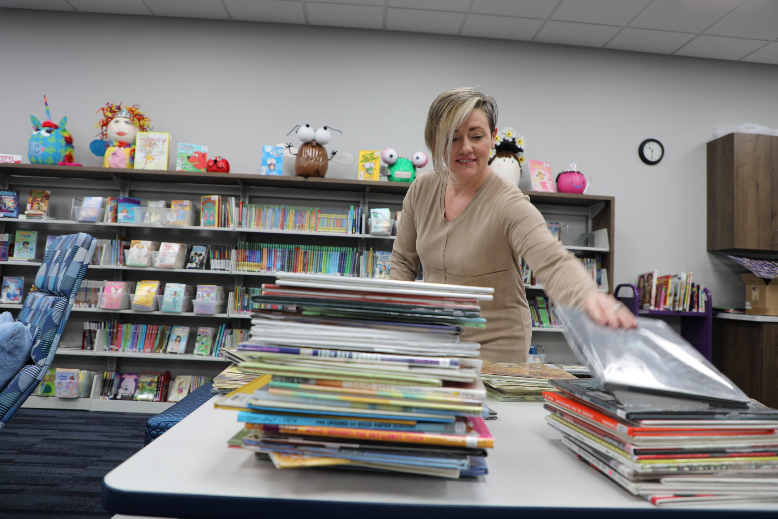 Library Aide Christy Allen organizes books for the Lower School Library’s collection, which includes 13,671 books in circulation.  Our Lower School students have checked out an average of 3,312 books per month since the start of the 2022-2023 school year.